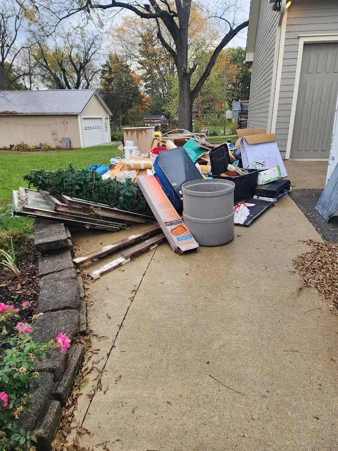 Dumpster being loaded with debris for 12 Yard Dumpster Rental in Marksville